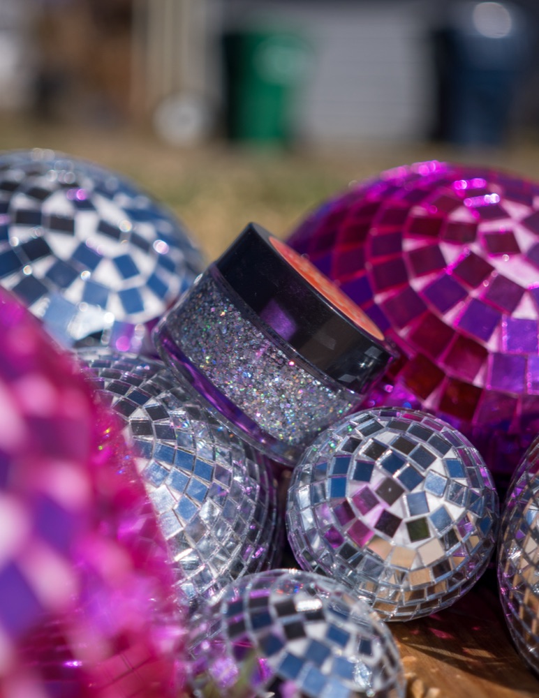 Disco — a jar of silver biodegradable face & body glitter among disco balls