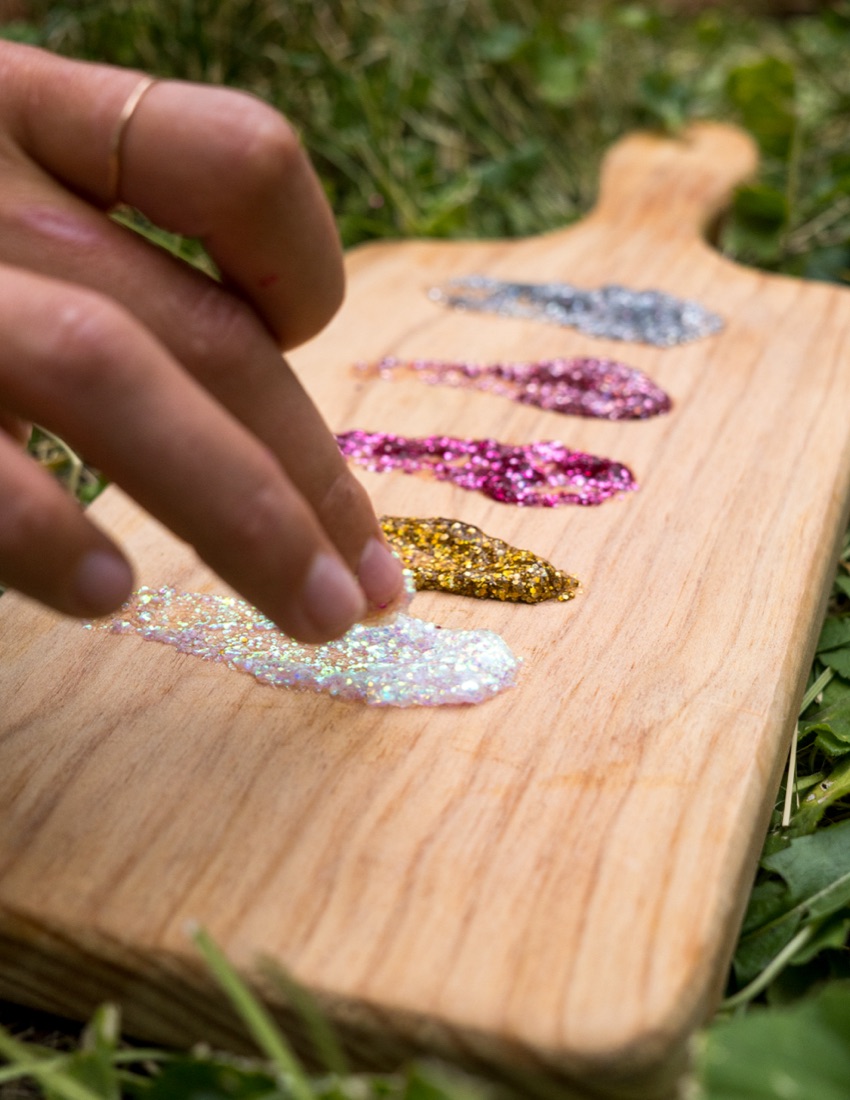 Swatches of Après Sparkles glitter shades laid out on a board